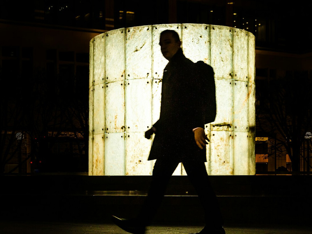 man walking in dark coat